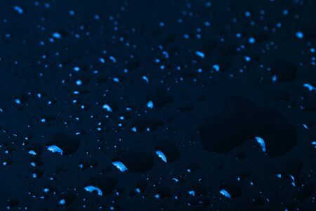 Drops of water on a color background. Blue. Shallow depth of field. Selective focus. Toned.の写真素材