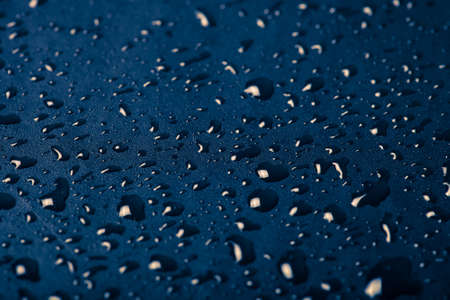 Drops of water on a color background. Blue. Shallow depth of field. Selective focus. Toned.