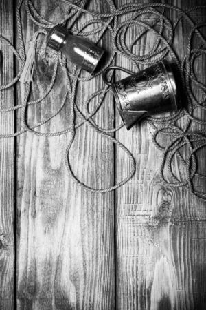 Rope, spices and metal utensils on old wooden burned table or board for background. Toned.の写真素材