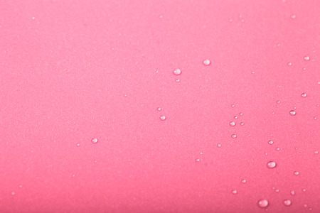Drops of water on a color background. Pink. Shallow depth of field. Selective focus. Toned.の写真素材