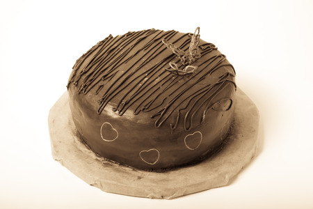 Chocolate homemade cake with gold decor. Toned.