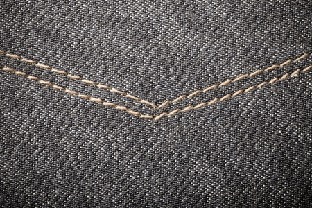 Surface of jeans cloth for textured background. Toned.
