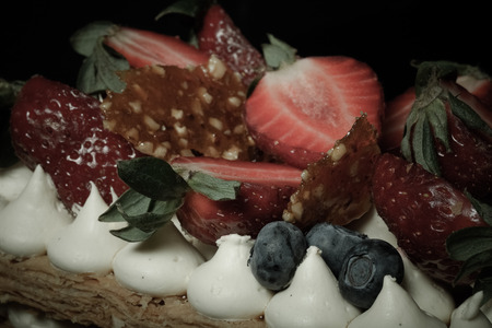 Puff homemade cake with cream and berries. Selective Focus. Shallow depth of field. Toned.