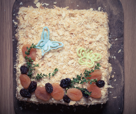 Homemade cake with chocolate decor and dried fruits. Toned.