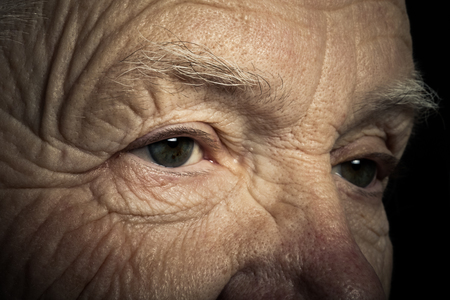 Portrait of elderly woman on dark background. Toned.の写真素材
