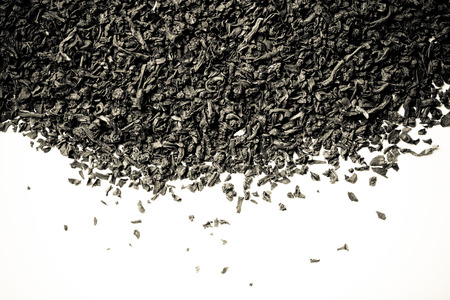 Dry black tea leaves as texture for background. Toned.の写真素材