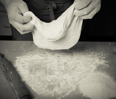 The process of making home bread by male hands. Toned.