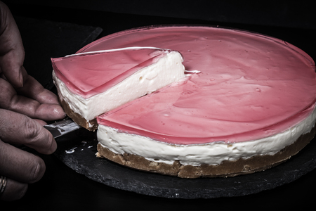 Fresh homemade cheesecake with pink jelly. Toned.の写真素材