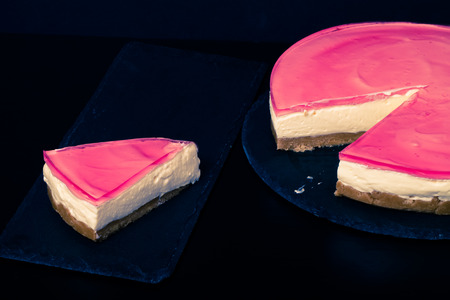 Fresh homemade cheesecake with pink jelly. Toned.の写真素材