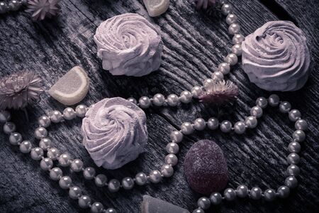 Fresh pink homemade zephyr - marshmallow on old wooden table. Toned.の写真素材