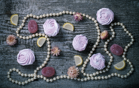 Fresh pink homemade zephyr - marshmallow on old wooden table. Toned.の写真素材
