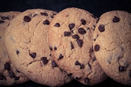 American cookies with chocolate drops on a black background. Toned.