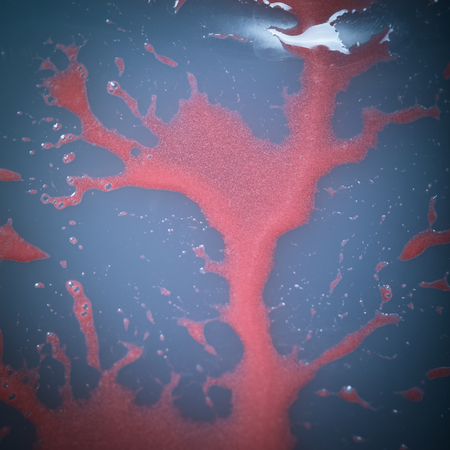 Stains of red mirror glaze on abstract surface. Toned.の写真素材