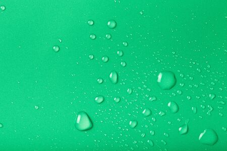 Drops of water on a color background. Green. Shallow depth of field. Selective focus. Toned.