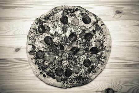 Fresh homemade pizza on light wooden table. Toned.の写真素材