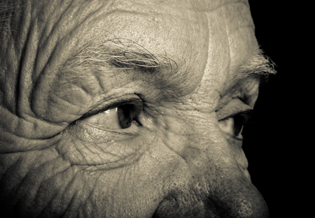 Portrait of elderly woman on dark background. Toned.の写真素材
