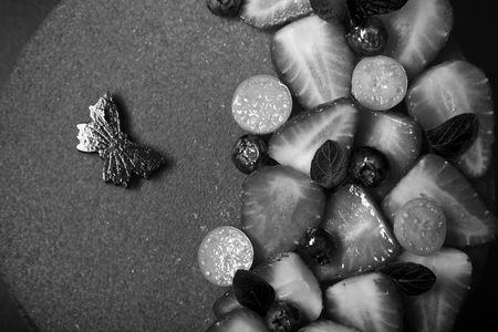 Many fresh berries on bright mousse cake. Toned.の写真素材