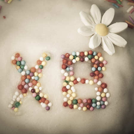 Fragment of Easter cake with letters. Toned.の写真素材