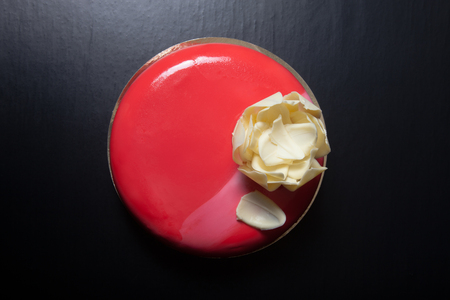 Homemade bright mousse cake with chocolate flower.の写真素材