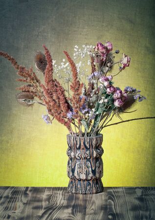 Bouquet of dry flowers on burlap background. Selective focus. Toned.の写真素材