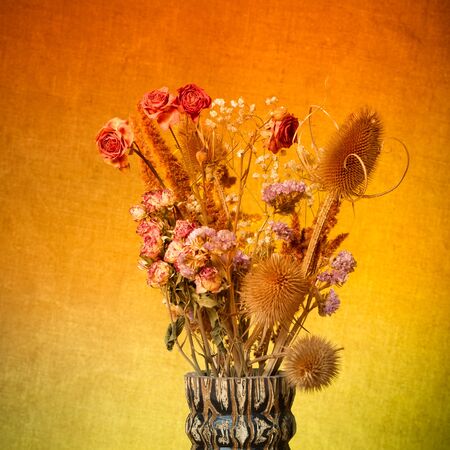 Bouquet of dry flowers on burlap background. Selective focus. Toned.の写真素材