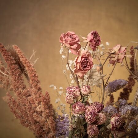 Bouquet of dry flowers on burlap background. Selective focus. Toned.の写真素材