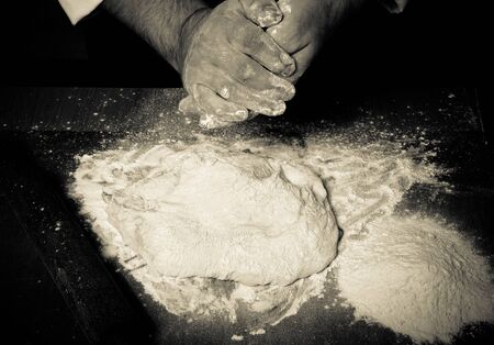 The process of making home bread by male hands. Toned.の写真素材
