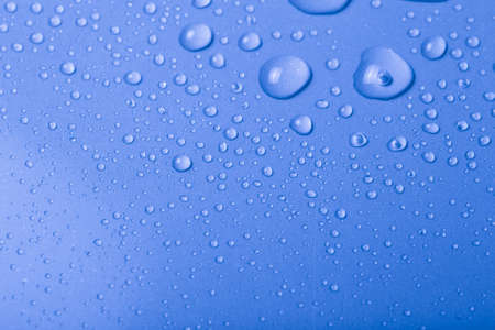 Drops of water on a color background. Blue. Shallow depth of field. Selective focus. Toned.