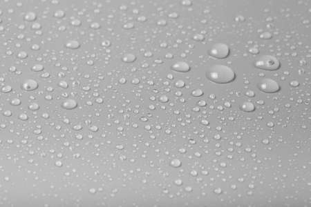 Drops of water on a color background. Gray. Shallow depth of field. Selective focus.の写真素材