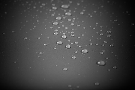 Drops of water on a color background. Gray. Shallow depth of field. Selective focus. Toned.の写真素材