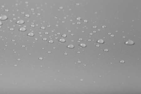 Drops of water on a color background. Gray. Shallow depth of field. Selective focus.の写真素材