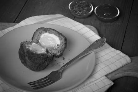 Fried cutlet with egg inside served on a plate. Selective focus. Toned.の写真素材