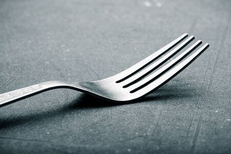 Lot of metal cutlery on a black background. Selective focus. Shallow depth of field. Toned.の写真素材