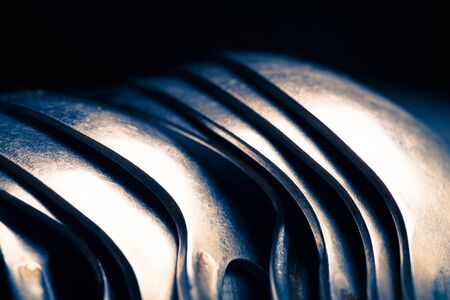 Lot of metal cutlery on a black background. Selective focus. Shallow depth of field. Toned.の写真素材