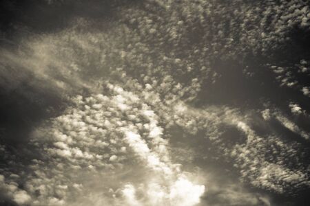 White clouds on a blue sky. Selective focus. Toned.