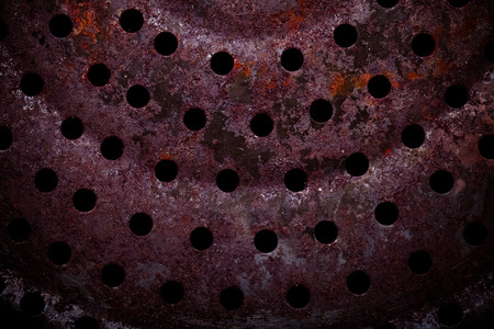 Old metal surface with holes for background. Toned.の写真素材