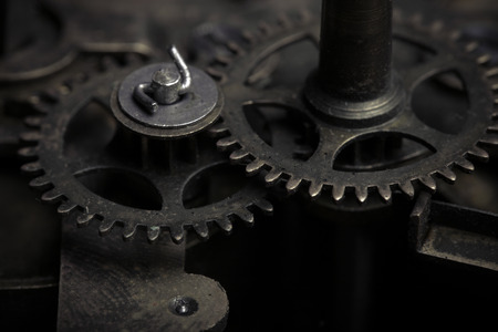 Old clockwork dirty with dust and lubricating oil. Selective focus. Shallow depth of field. Toned.