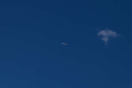 Airplane on a blue sky. Selective focus.