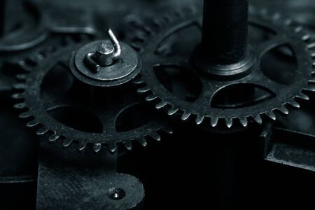 Old clockwork dirty with dust and lubricating oil. Selective focus. Shallow depth of field. Toned.の写真素材