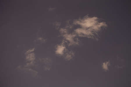 White clouds on a blue sky. Selective focus. Toned.