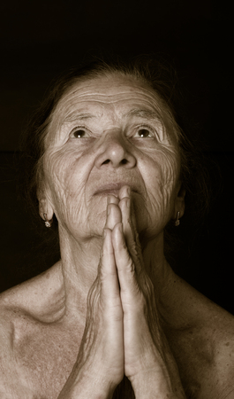 Portrait of elderly woman prayingの写真素材