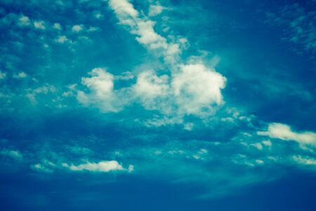 White clouds on a blue sky. Selective focus. Toned.の写真素材