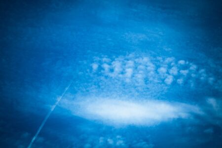 White clouds on a blue sky. Selective focus. Toned.