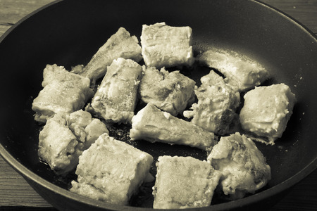 Fried fish fillet on a frying pan. Toned.の写真素材