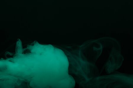 Cloud of smoke on black background. Selective focus. Toned.の写真素材