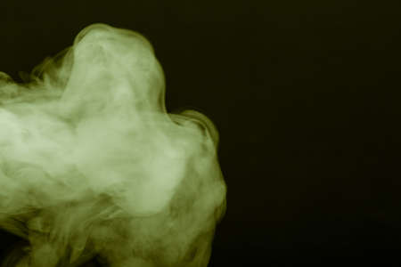 Cloud of smoke on black background. Selective focus. Toned.の写真素材