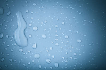 Drops of water on a color background. Toned.