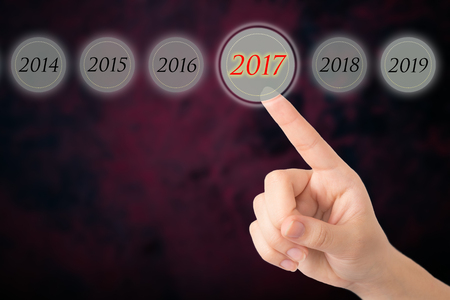 Hand of a young girl points to a figures 2017.