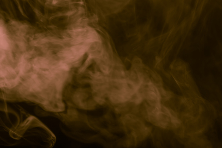 Cloud of smoke on black background. Selective focus. Toned.