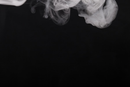Cloud of smoke on black background. Selective focus.の写真素材